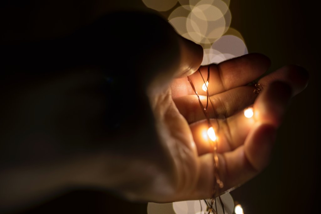 hand holding string of lights