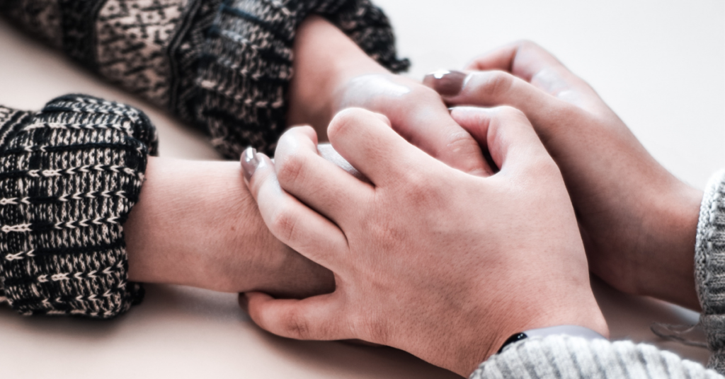 two women holding hands expressingtwo women holding hands support